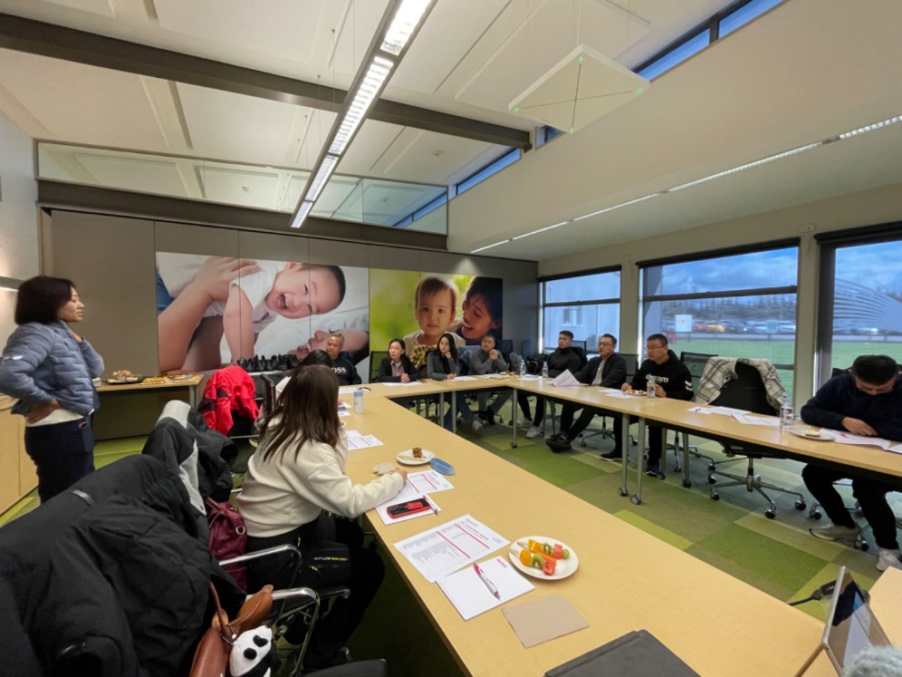 A group of people sitting at a table
Description automatically generated